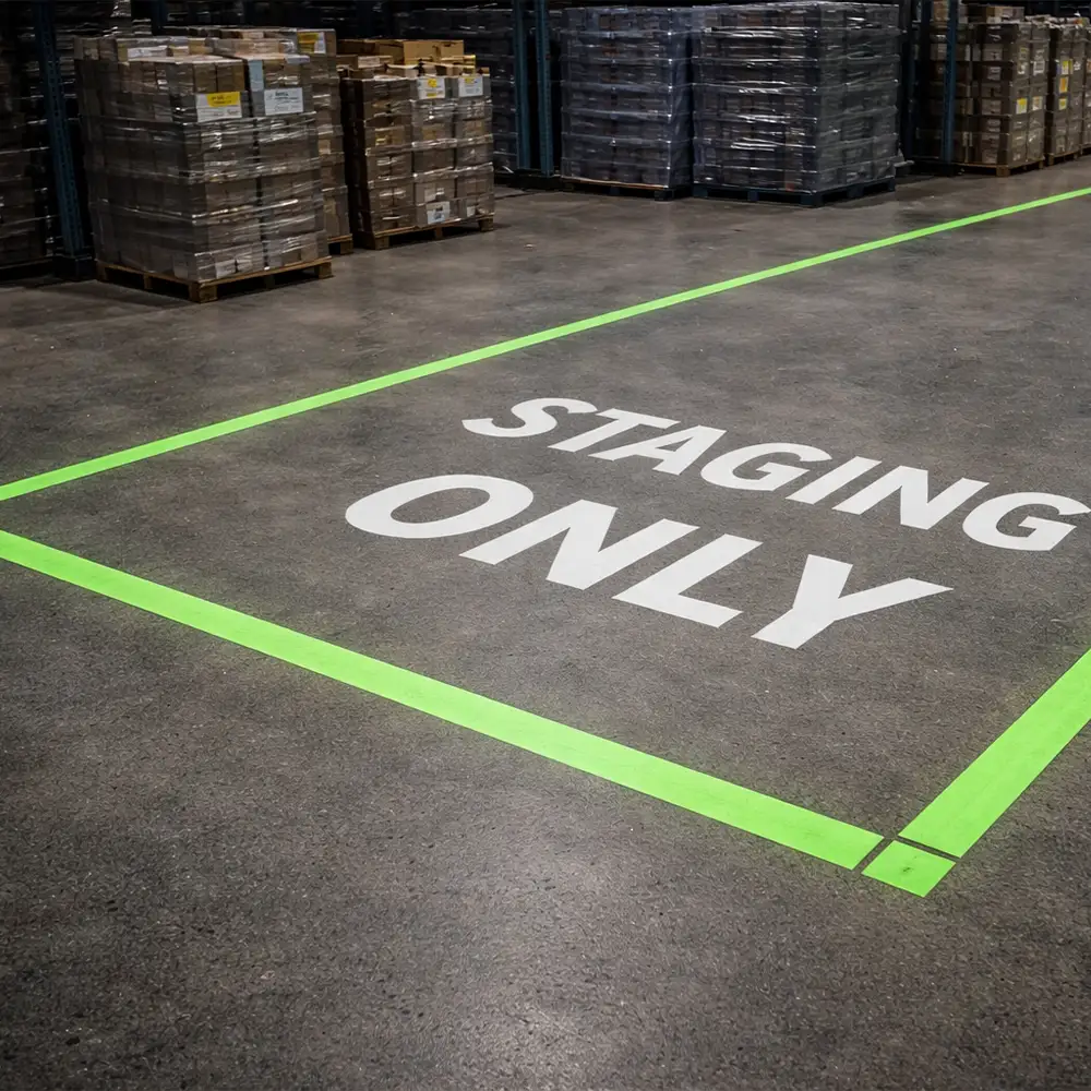 Staging area boundaries marked by green laser lines in a warehouse